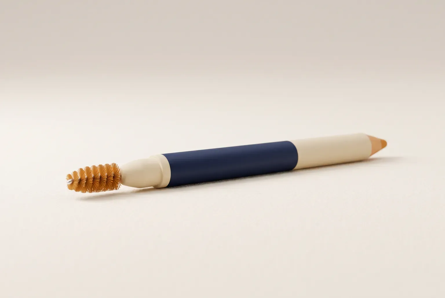 Illustration: a slim cream and navy pencil with a small amber spoolie brush on one end lying on a plain cream surface, drawn as a soft 3D render. Not a real product.