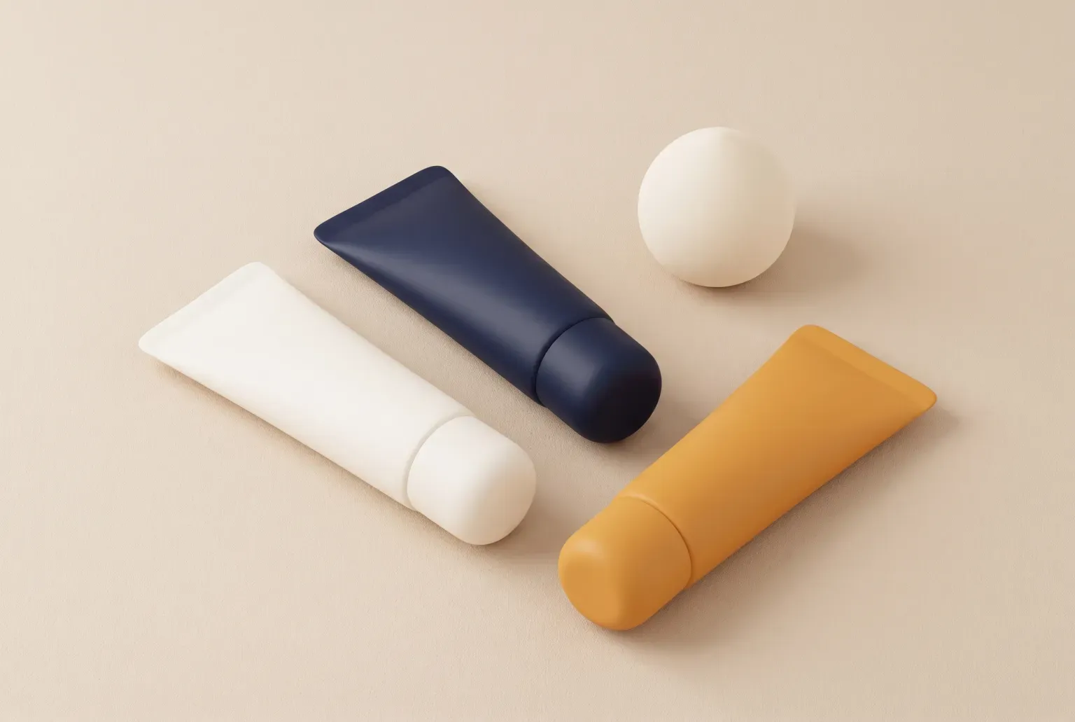 Illustration: three plain concealer tubes in white, navy and amber beside a round makeup sponge on a beige surface, drawn as a soft 3D render. Not a real product.