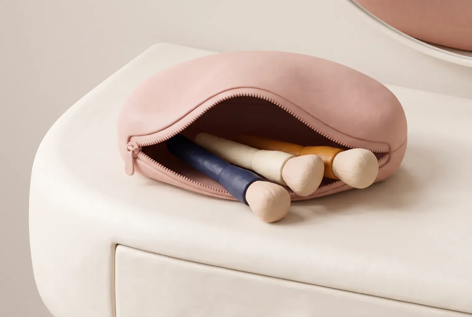 Illustration: a plain blush pink zippered cosmetic pouch lying open with a few unbranded makeup brushes on a white vanity, drawn as a soft 3D render. Not a real product.
