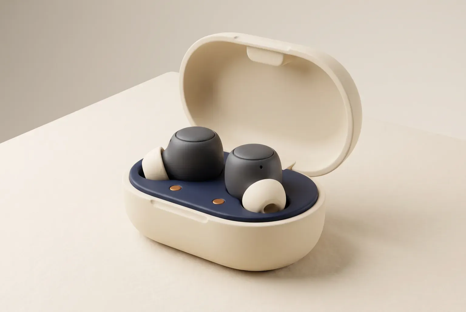 Illustration: a pair of dark gray wireless earbuds with cream ear tips resting in an open oval cream charging case with a navy lining, on a pale tabletop, drawn as a soft 3D render. Not a real product.