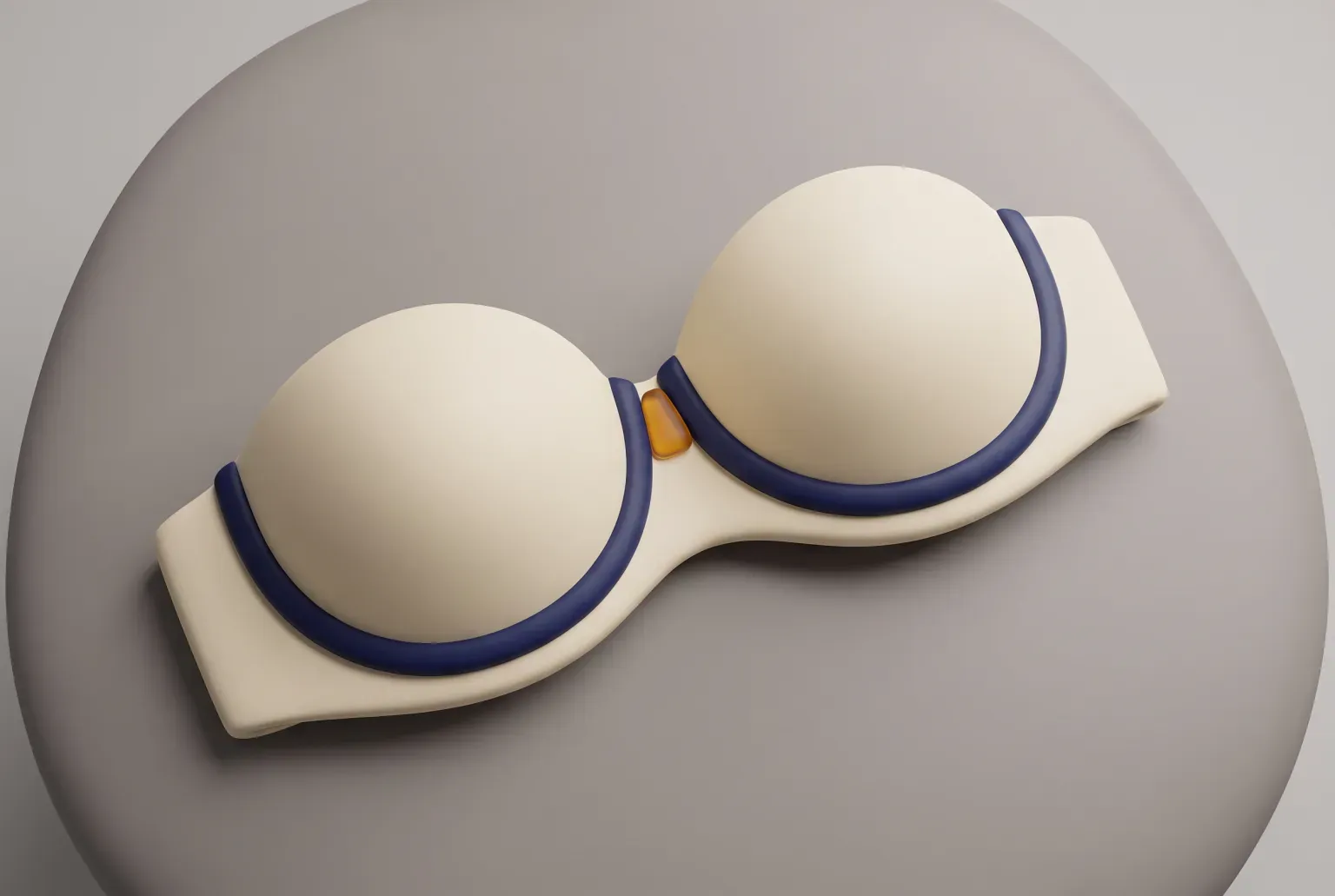 Illustration: a cream-colored padded bra with smooth rounded cups and navy and amber strap sliders laid flat on a pale linen surface, drawn as a soft 3D render. Not a real product.