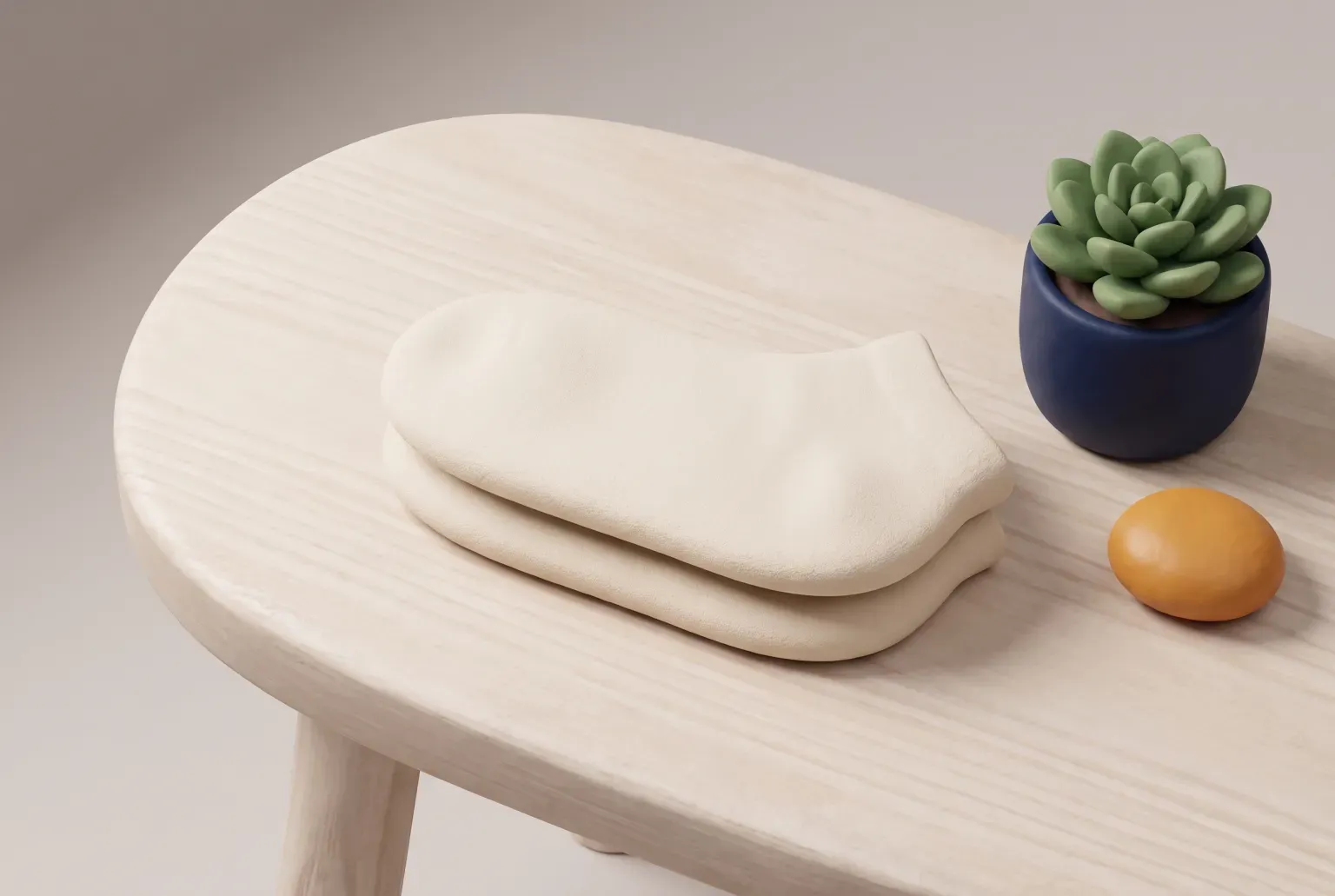 Illustration: a pair of cream rounded socks with amber toes and heels resting on a smooth rock beside a small green plant, drawn as a soft 3D render. Not a real product.